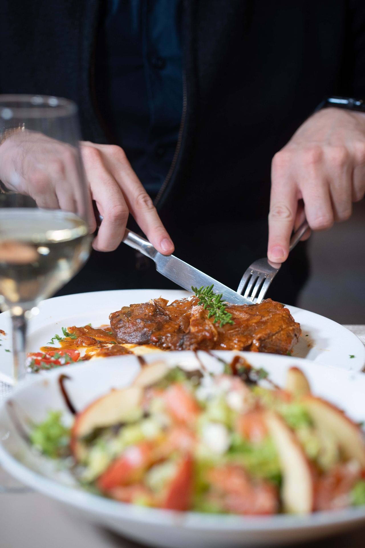 Guest enjoying lamb and salad at Majestic