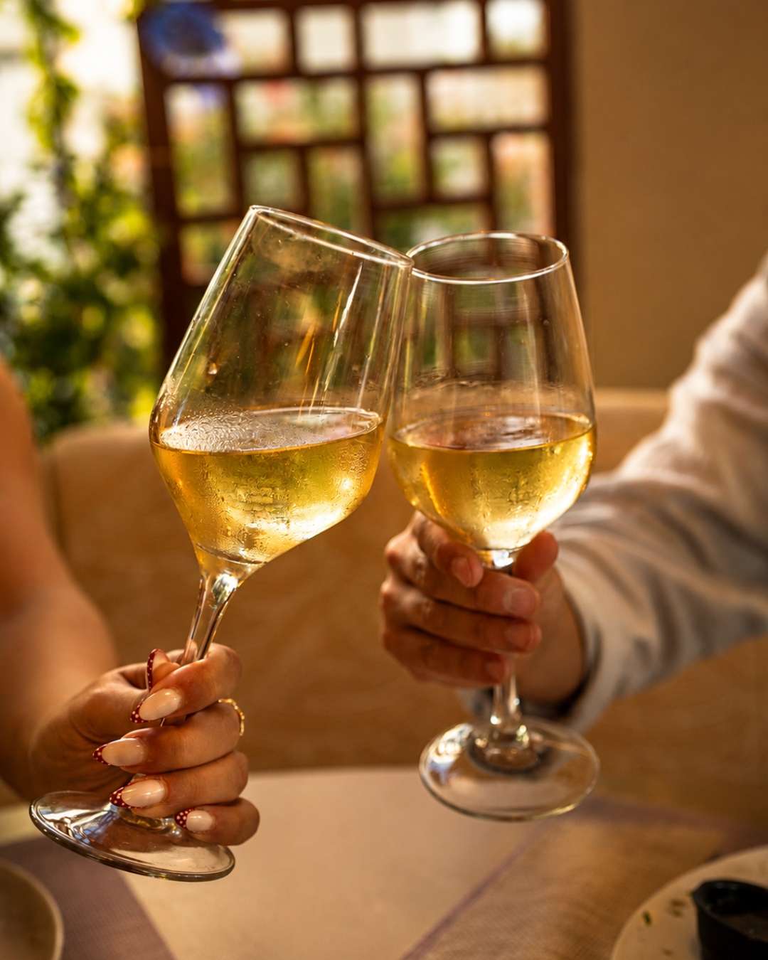 Two glasses of chilled white wine toasting at Majestic