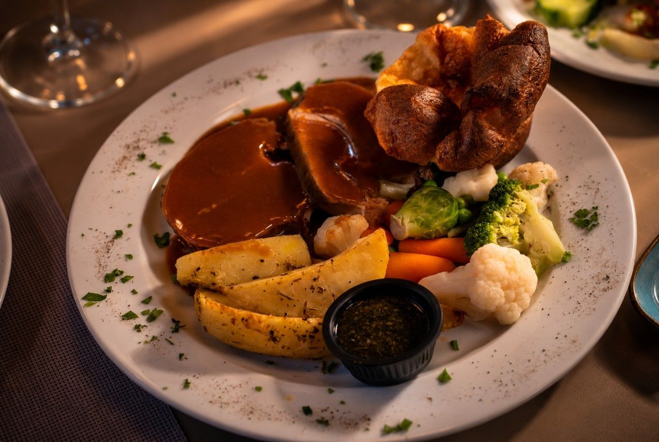 Roast beef with gravy, roast potatoes and Yorkshire pudding