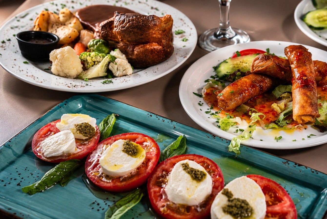 Trio of plates: roast chicken, spring rolls and caprese salad